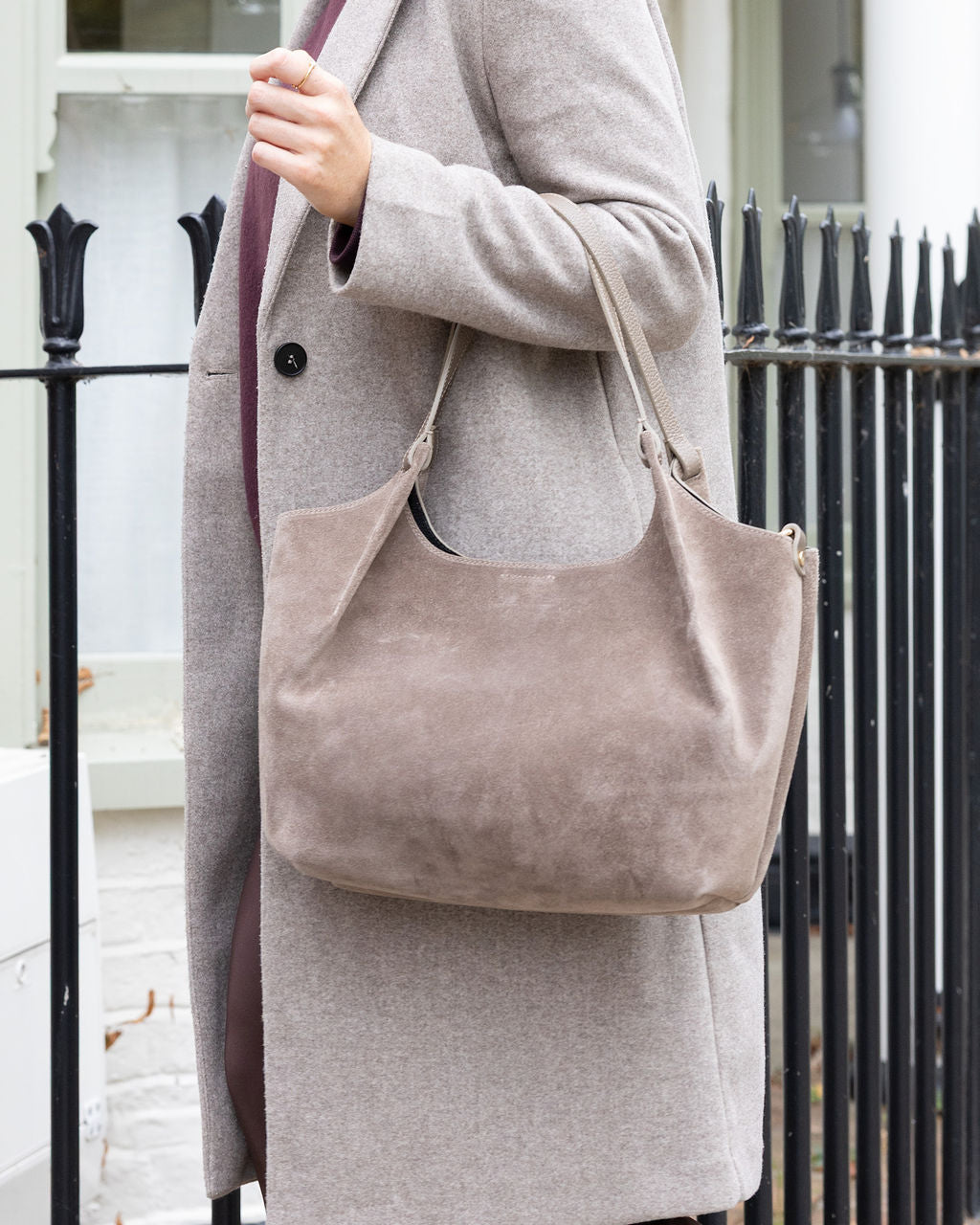 lady holding suede tote bag in taupe 
