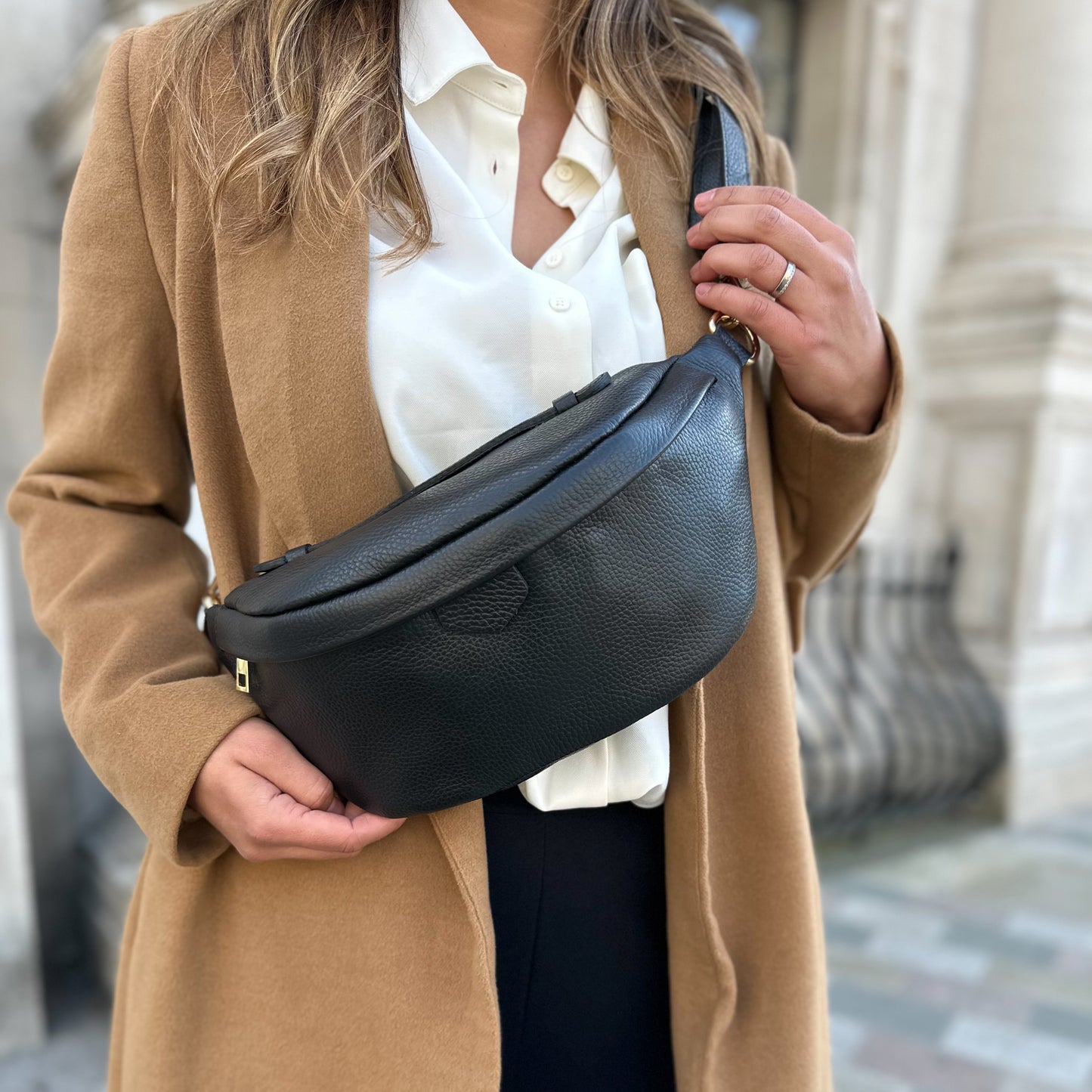 Lady wearing a black leather bumbag 