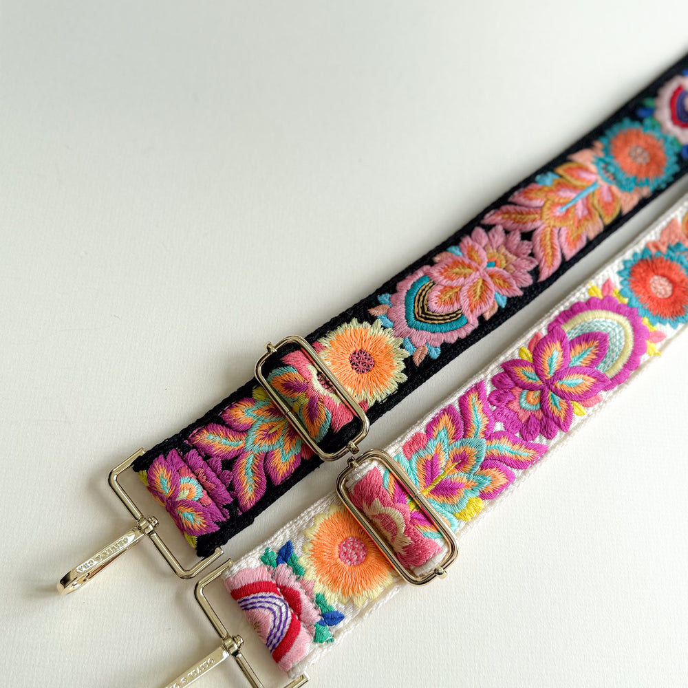 Colorful embroidered straps with floral patterns on a white background