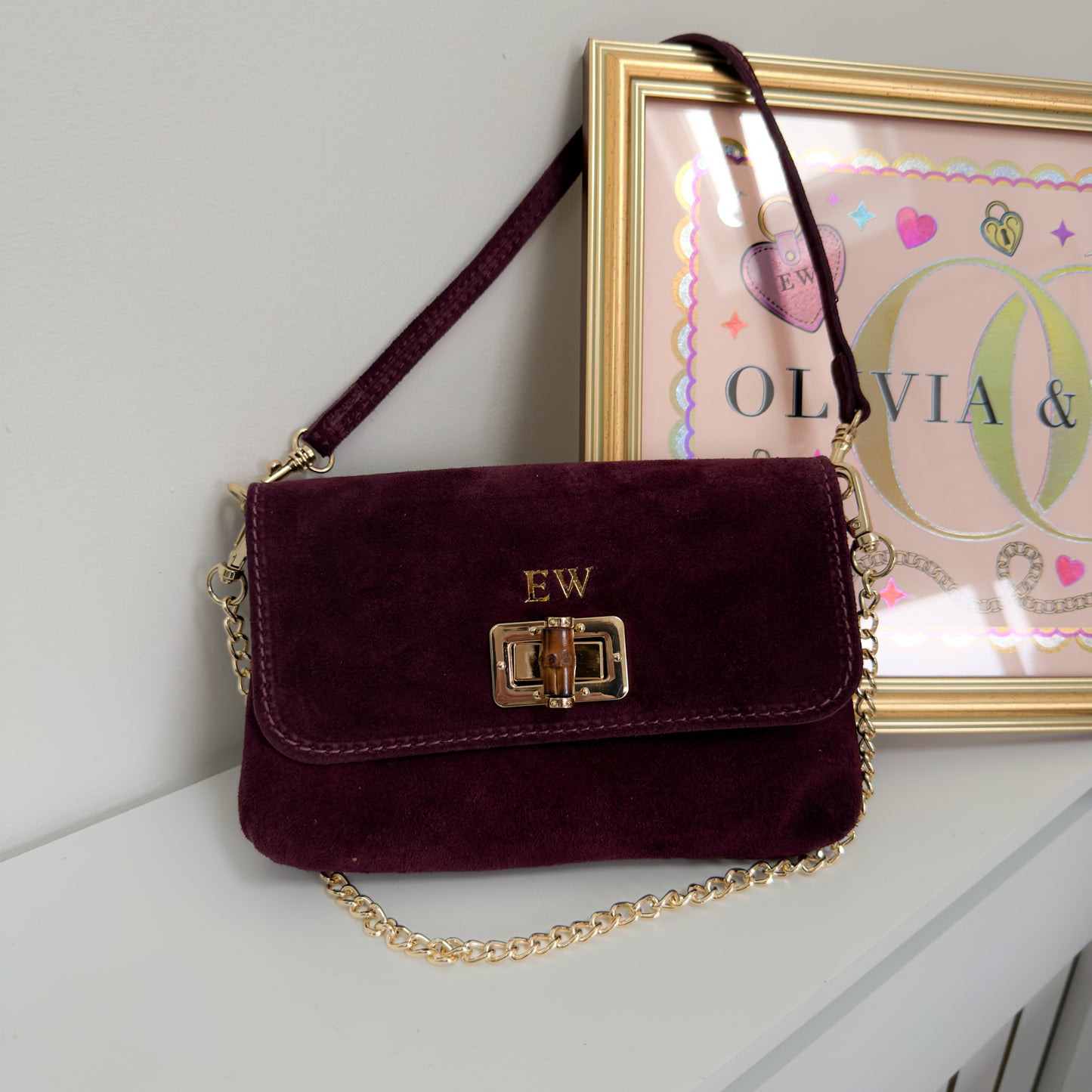 Suede clutch bag in plum red 
