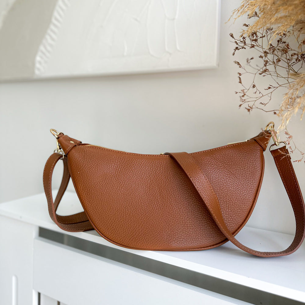 Lola personalised leather crossbody bag worn as a shoulder sling