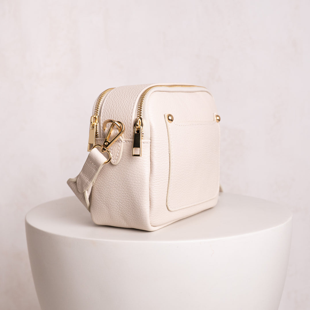 side veiw on double zip leather crossbody bag cream

