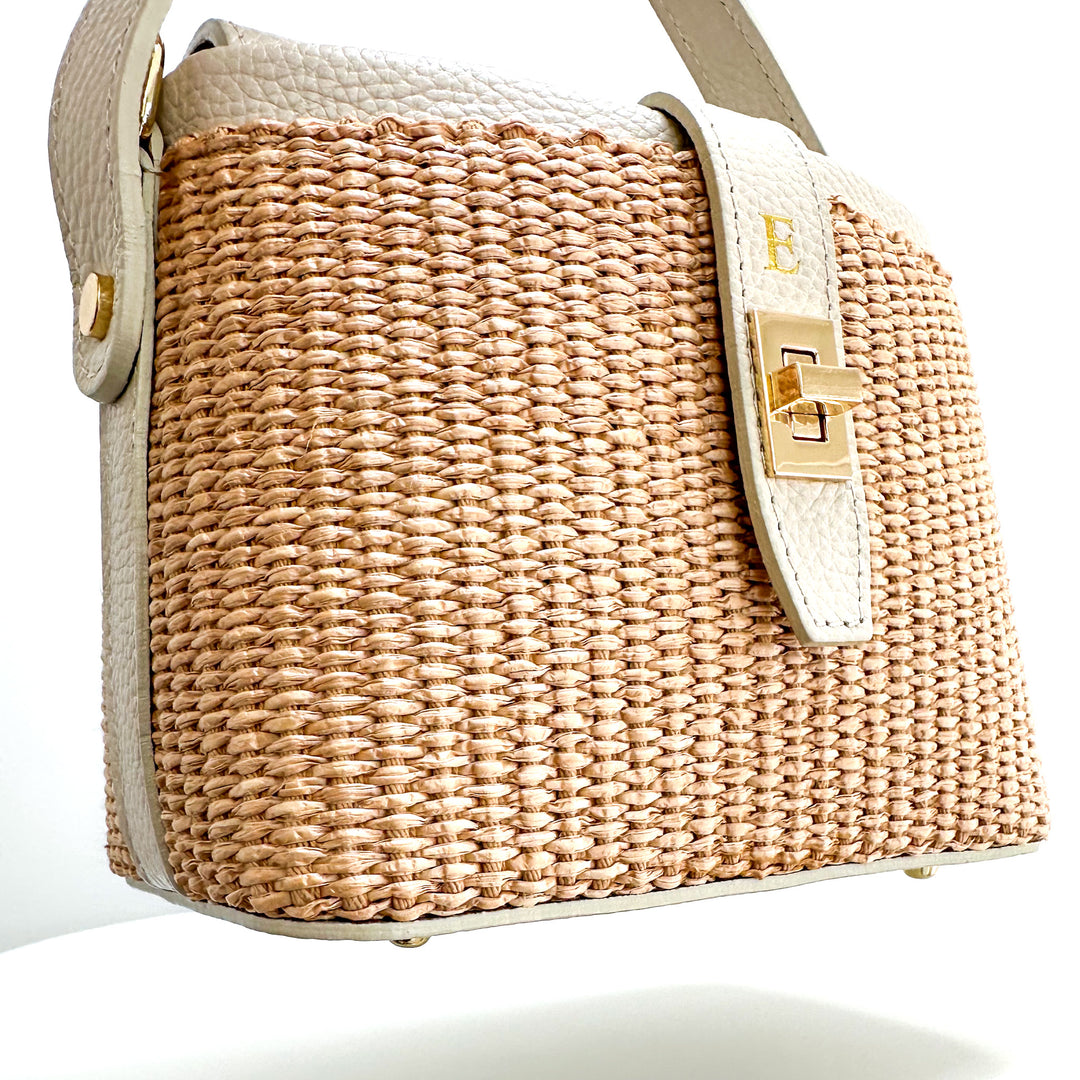 Woven RAFFIA handbag with beige strap on a white background