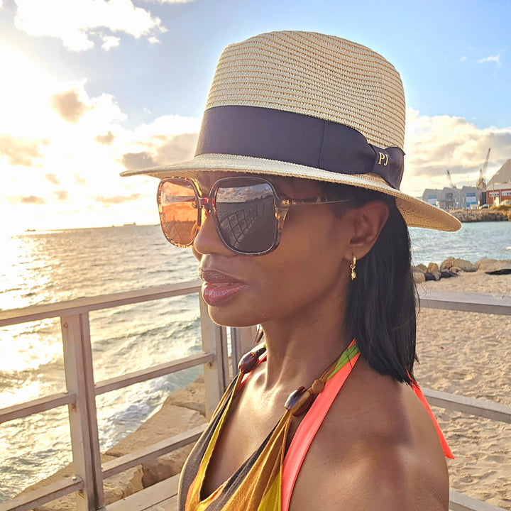 lady wearing beach hat at beach 